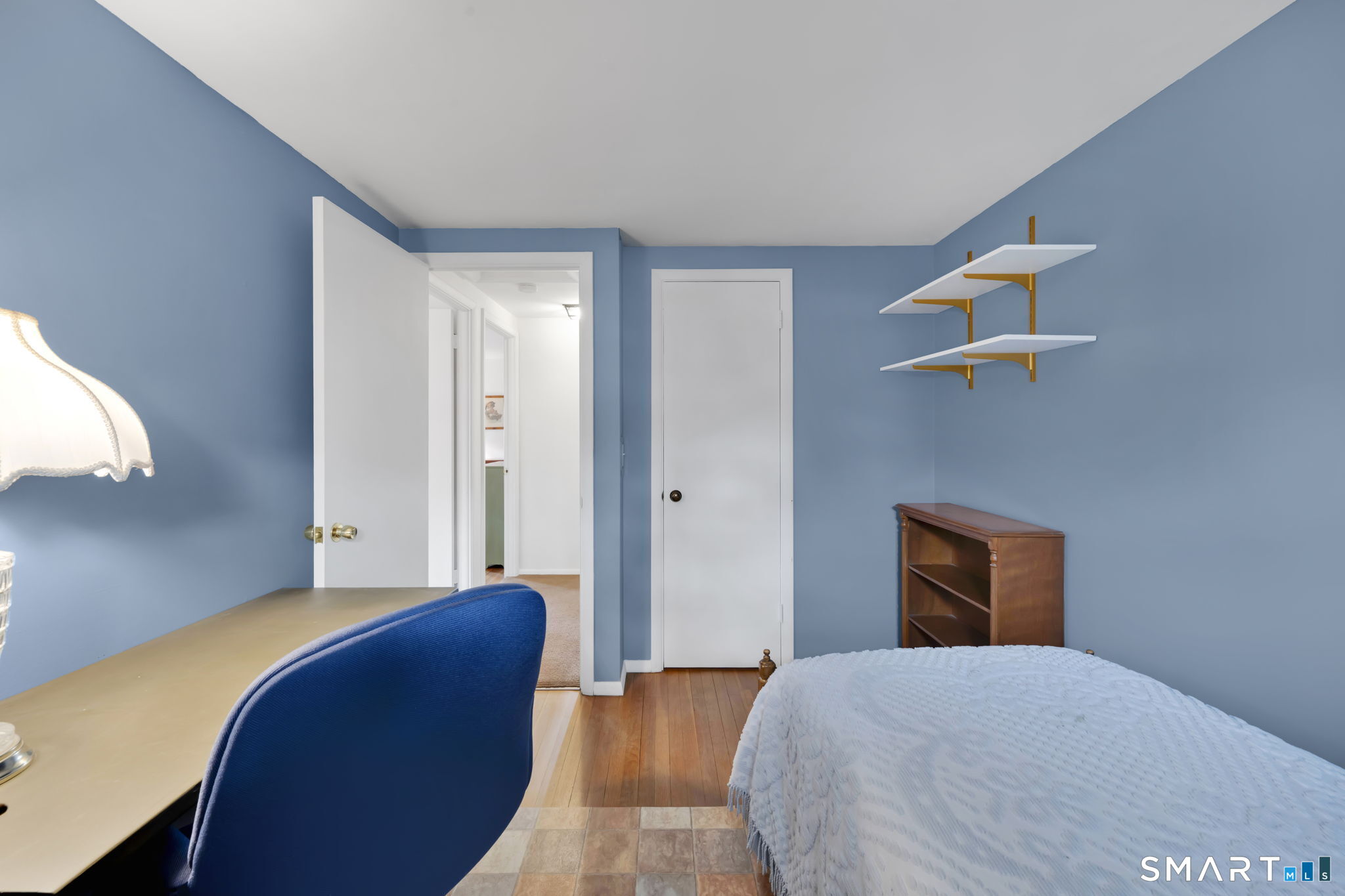 50 Carr Street Wallingford, CT 06492 - Photo 26 of 34 a bedroom with a bed and a chandelier