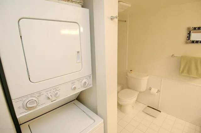 a bathroom with a toilet and a mirror