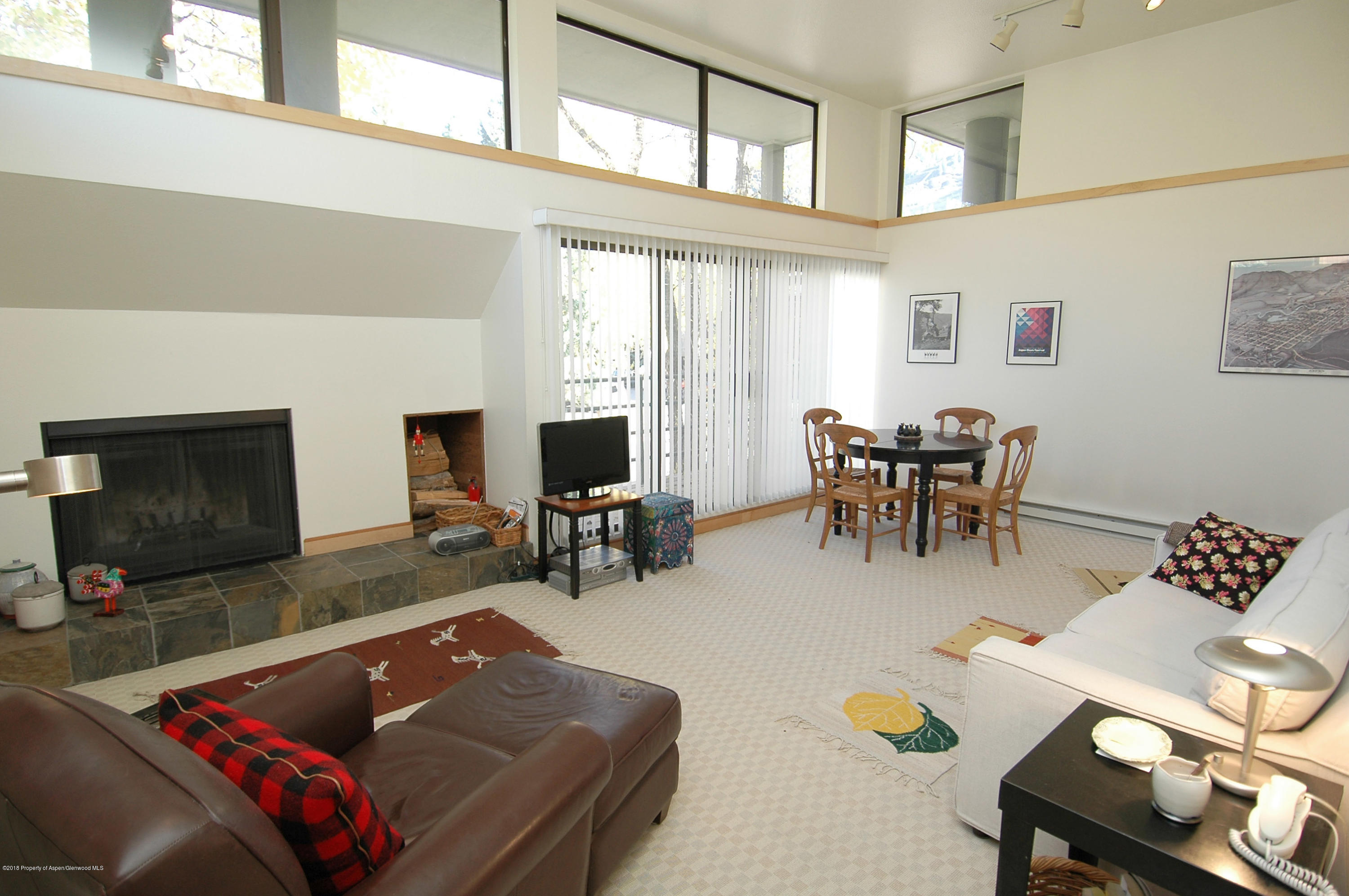 311 South Aspen Street, Unit 6 Aspen, CO 81611 - Photo 2 of 12 a living room with furniture and a flat screen tv