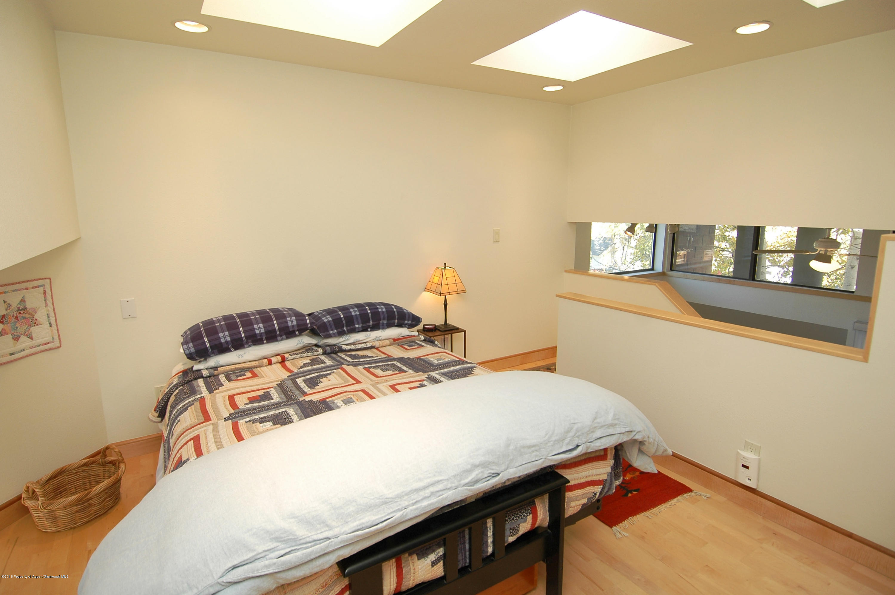 311 South Aspen Street, Unit 6 Aspen, CO 81611 - Photo 5 of 12 a bedroom with a bed and a table in it