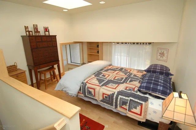 a bed sitting in a bedroom next to a window