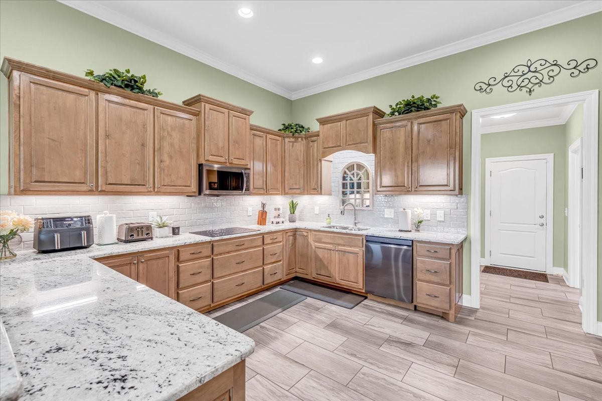 667 Rutherford Lane Smithville, TN 37166 - Photo 27 of 89 a kitchen with granite countertop a sink stainless steel appliances and cabinets