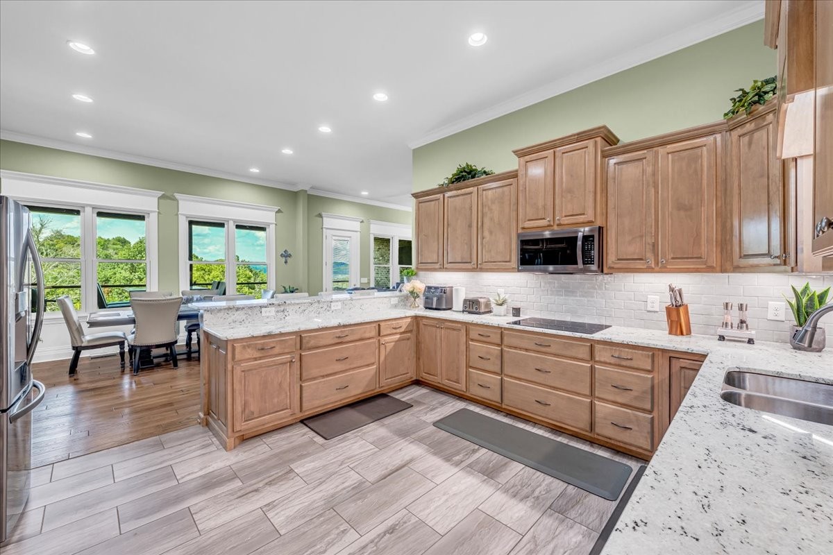 667 Rutherford Lane Smithville, TN 37166 - Photo 28 of 89 a kitchen with kitchen island granite countertop a sink cabinets and stainless steel appliances