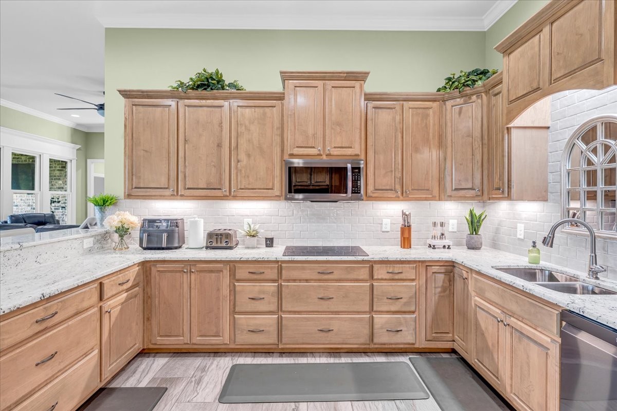 667 Rutherford Lane Smithville, TN 37166 - Photo 31 of 89 a kitchen with granite countertop a sink stainless steel appliances and cabinets