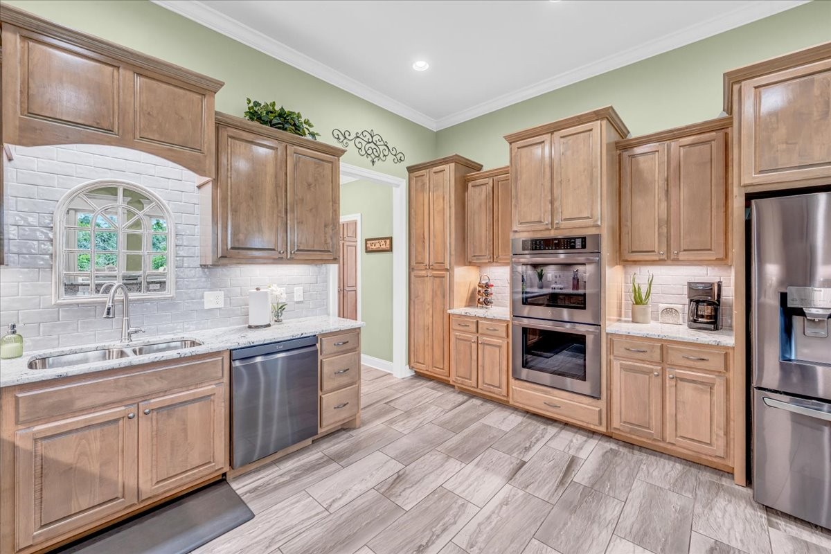 667 Rutherford Lane Smithville, TN 37166 - Photo 33 of 89 a kitchen with kitchen island granite countertop a sink cabinets stainless steel appliances and a window