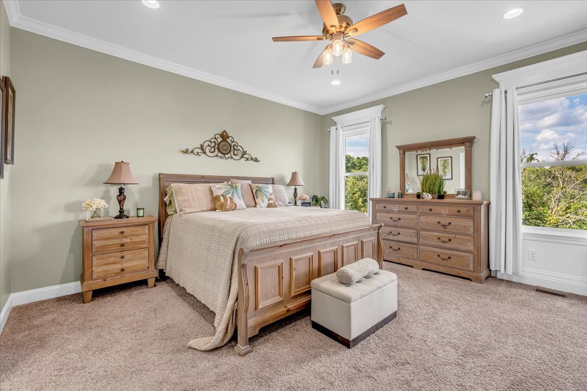 667 Rutherford Lane Smithville, TN 37166 - Photo 40 of 89 a spacious bedroom with a bed and a chandelier