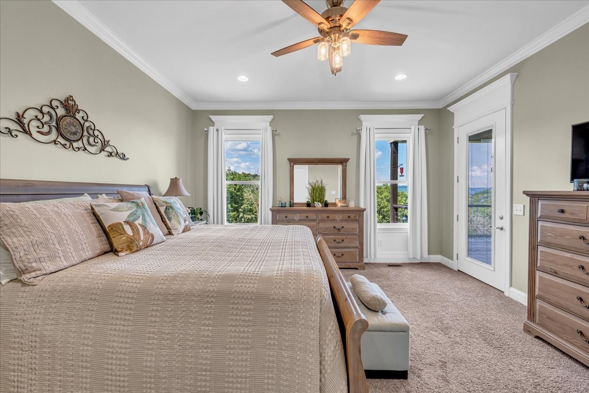 667 Rutherford Lane Smithville, TN 37166 - Photo 50 of 89 a bedroom with a large bed and a chandelier