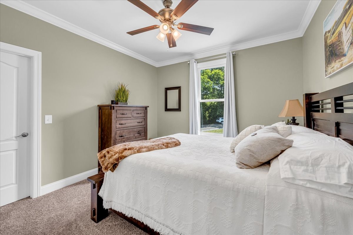 667 Rutherford Lane Smithville, TN 37166 - Photo 58 of 89 a bedroom with a bed and wooden floor