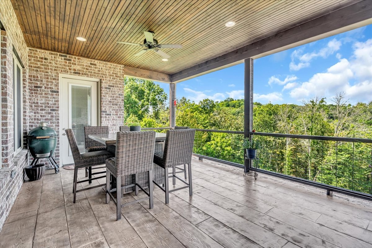 667 Rutherford Lane Smithville, TN 37166 - Photo 62 of 89 a view of a patio with table and chairs and wooden floor