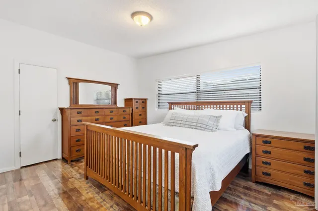 a bedroom with double bed and a dresser