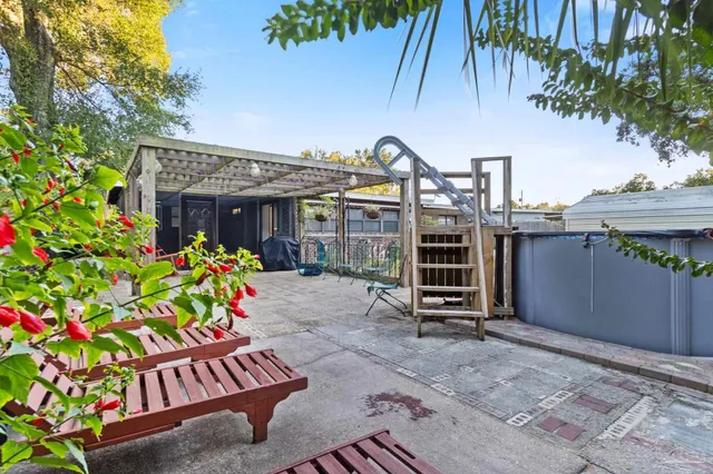 a backyard of a house with table and chairs