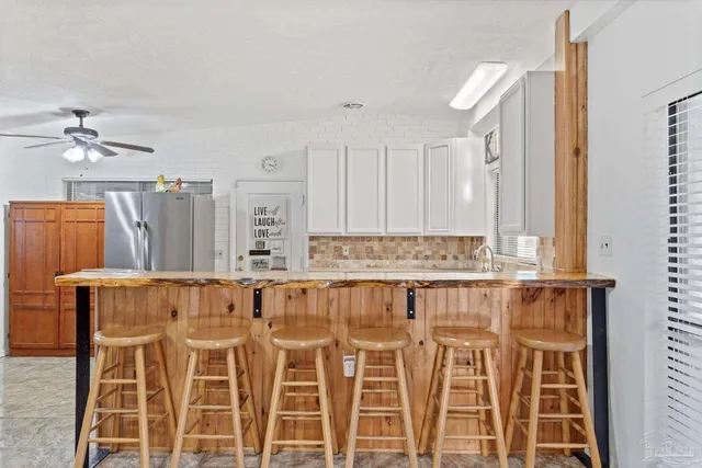 a view of a kitchen with table and chairs