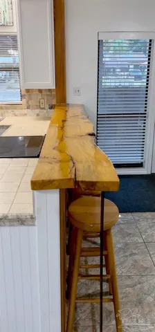 a bathroom with a granite countertop sink and white cabinets