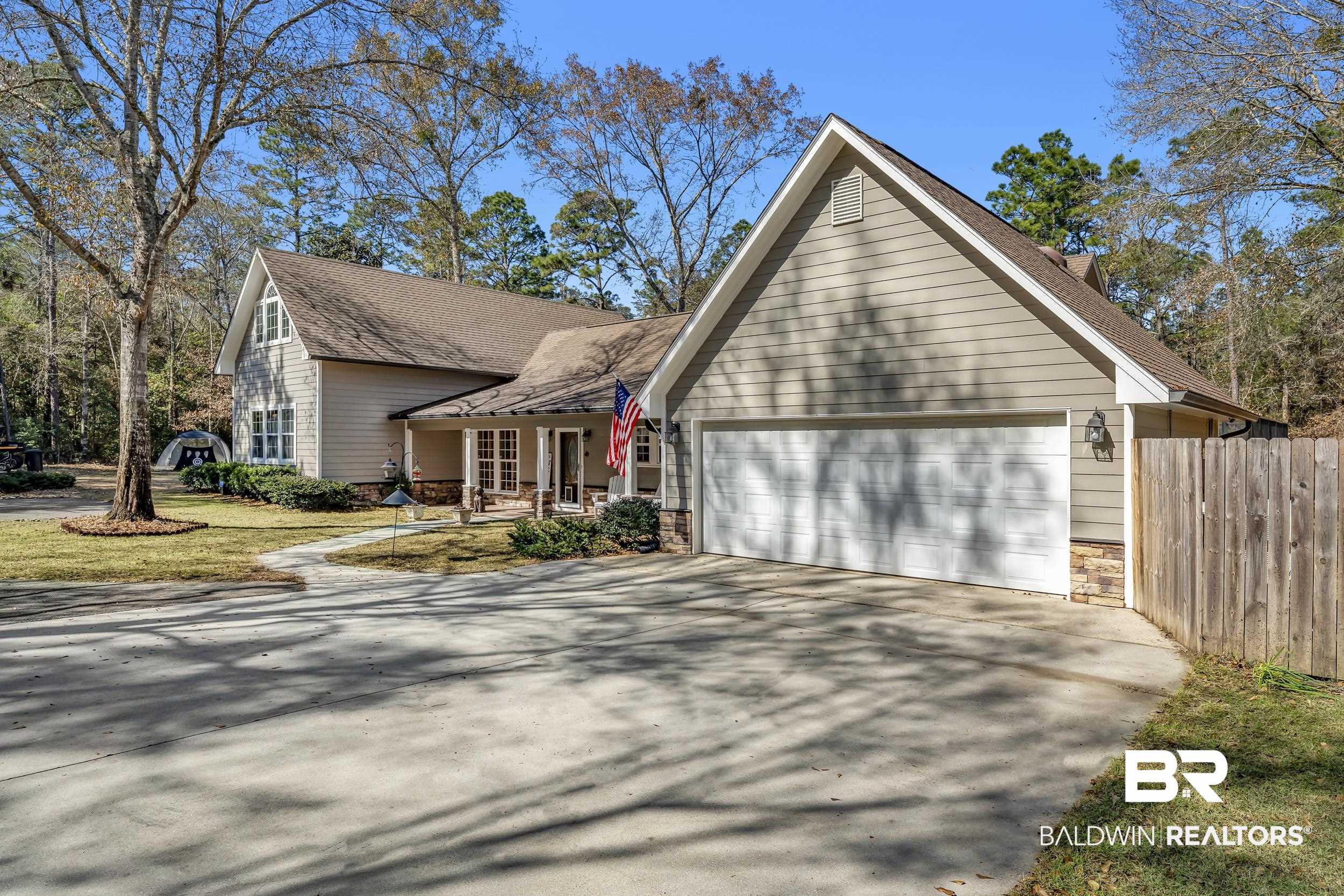 22929 Highway 98 Foley, AL 36535 - Photo 40 of 54 Traditional-style home featuring stone siding, concrete driveway, a porch, a garage, and roof with shingles