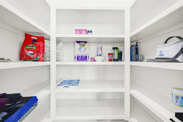 a cabinet with storage and utility room