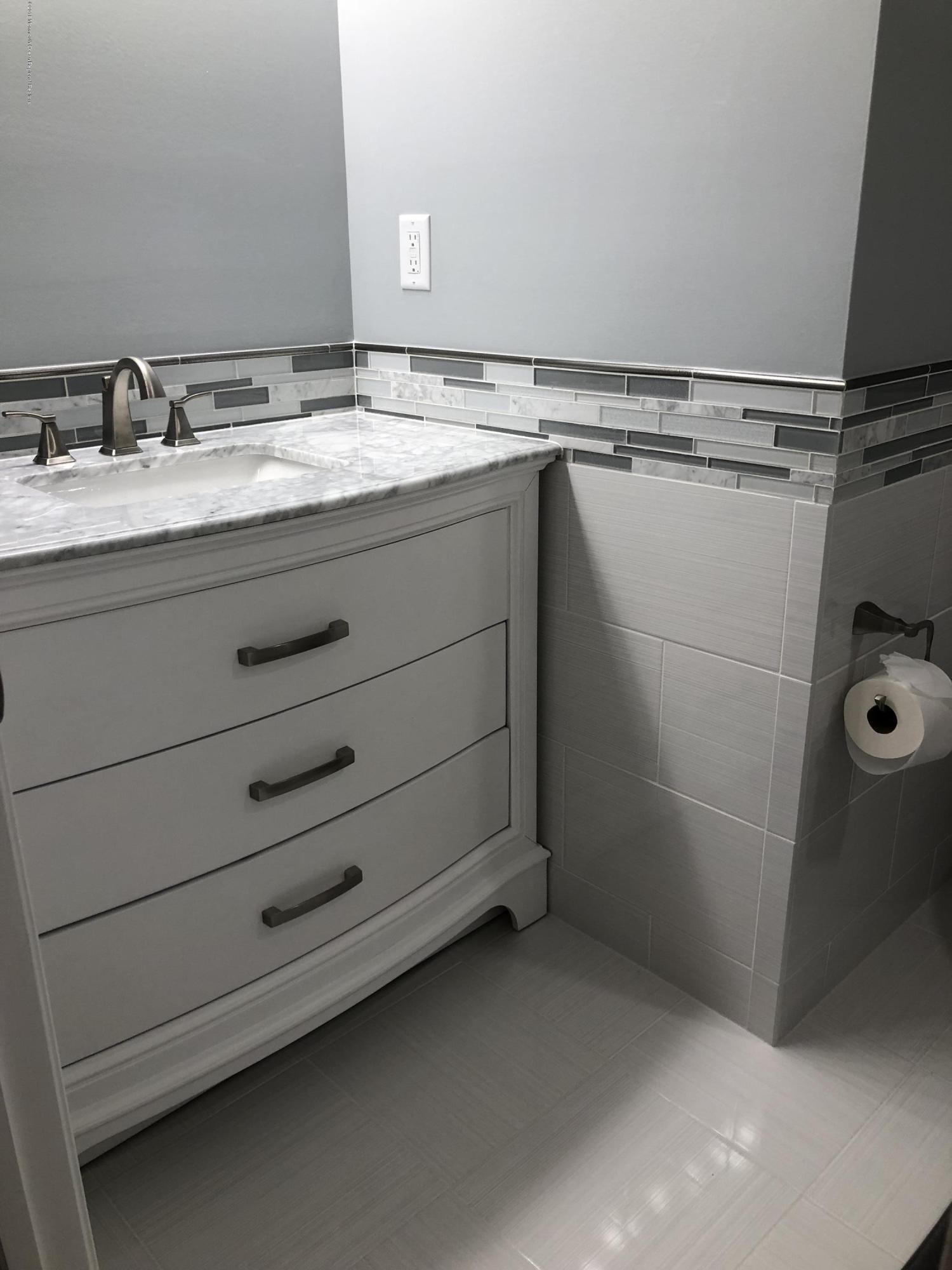 100 Sargent Road Freehold, NJ 07728 - Photo 2 of 30 a bathroom with a granite countertop sink and a mirror