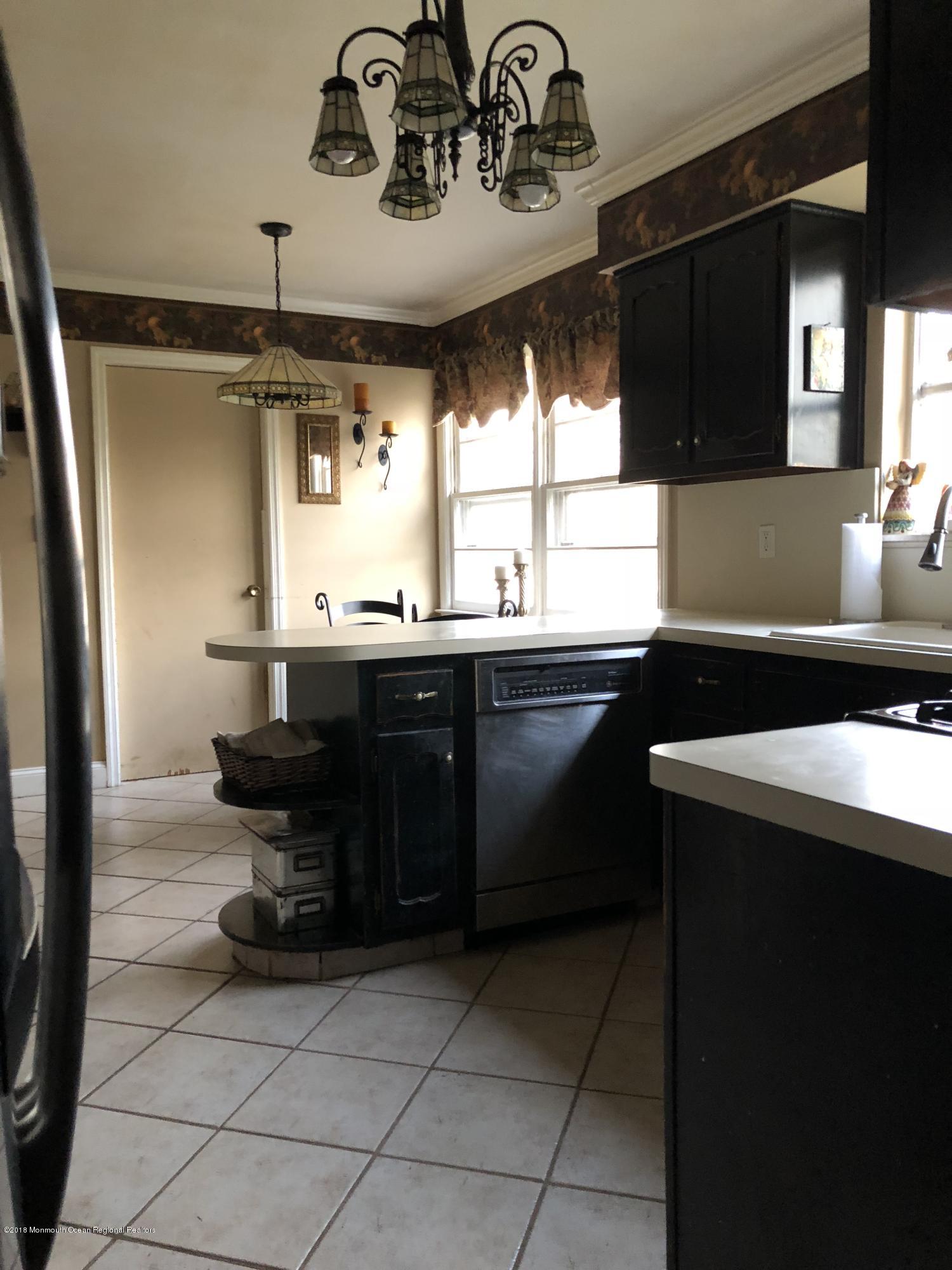 100 Sargent Road Freehold, NJ 07728 - Photo 11 of 30 a kitchen with a sink and cabinets