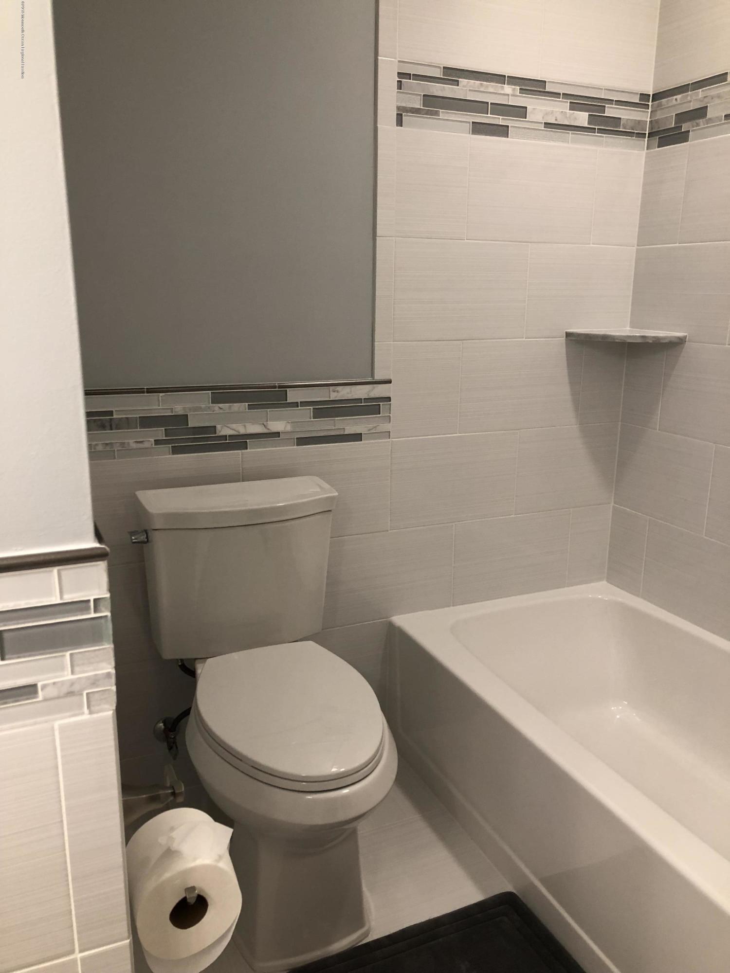 100 Sargent Road Freehold, NJ 07728 - Photo 13 of 30 a bathroom with a toilet and a bathtub