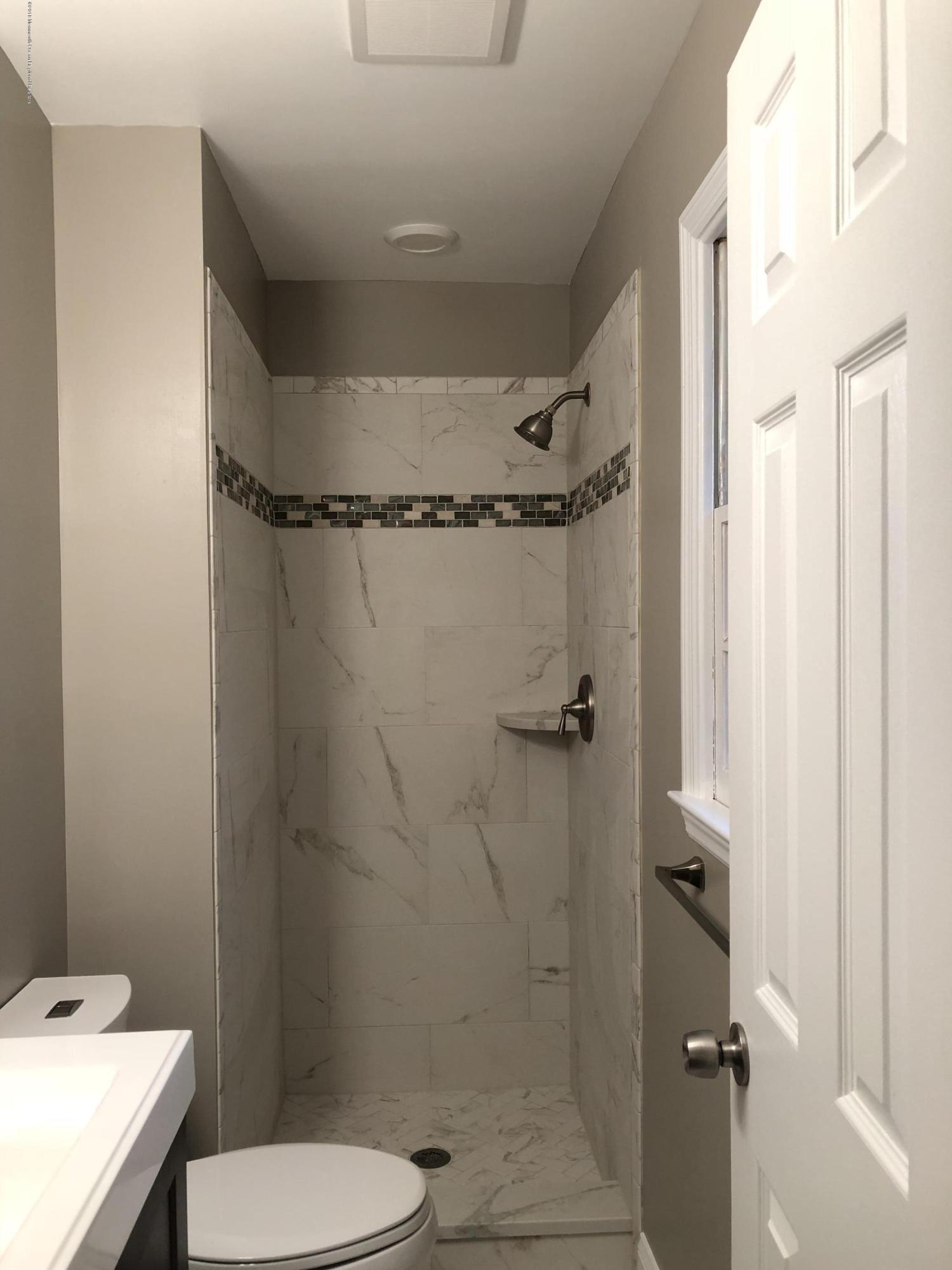 100 Sargent Road Freehold, NJ 07728 - Photo 14 of 30 a bathroom with a sink a toilet and shower