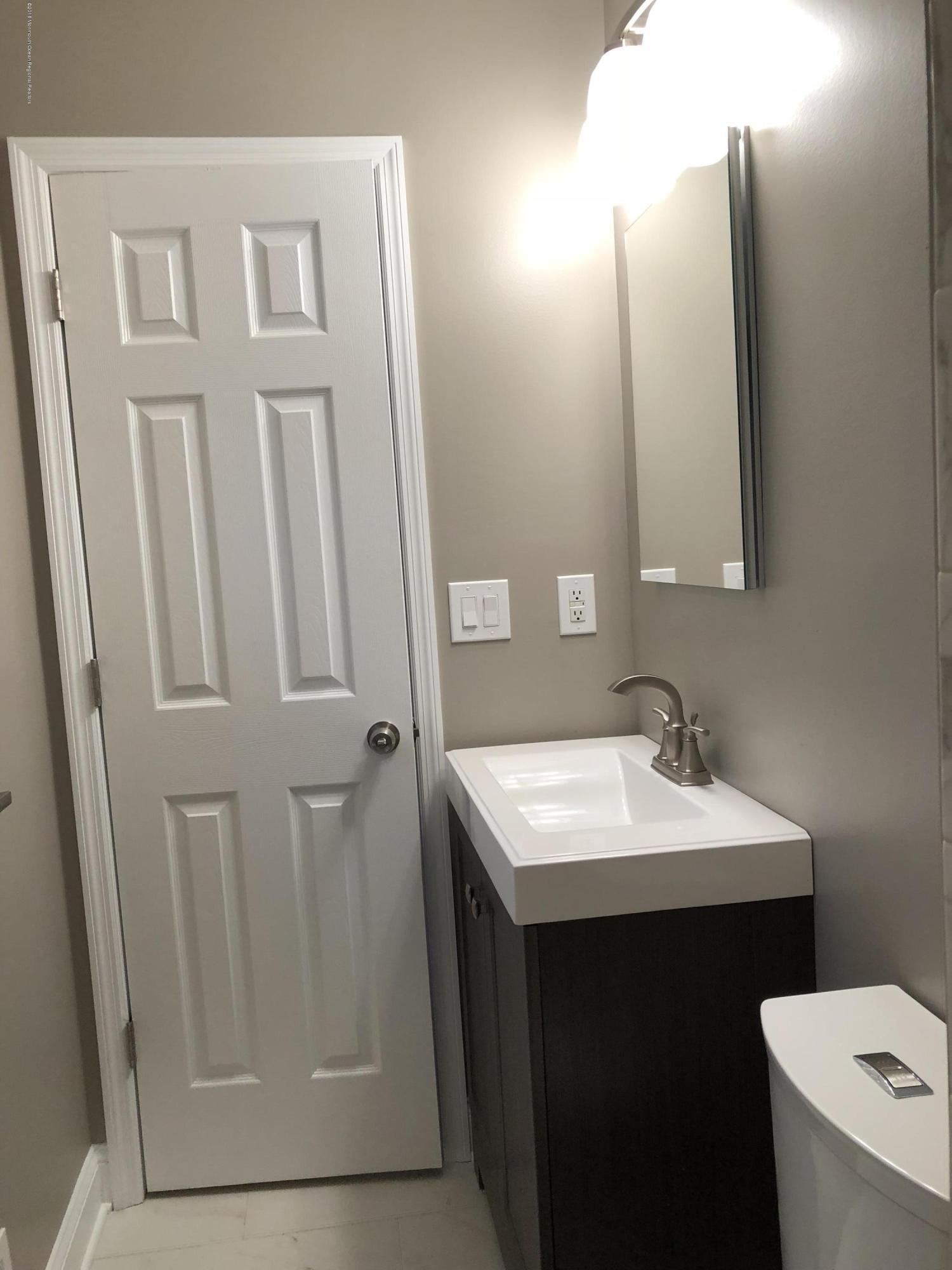 100 Sargent Road Freehold, NJ 07728 - Photo 15 of 30 a bathroom with a sink a toilet and mirror