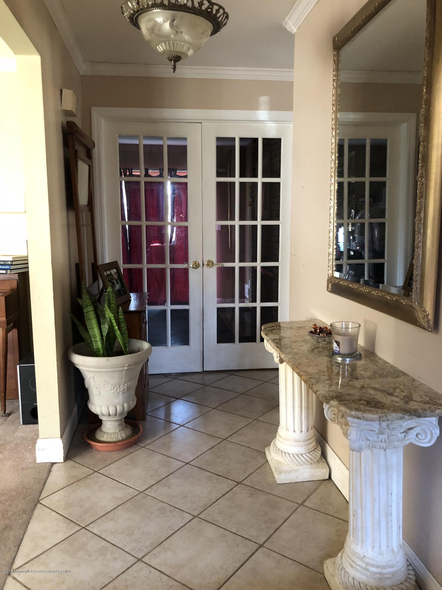 100 Sargent Road Freehold, NJ 07728 - Photo 3 of 30 a view of a patio with table and chairs