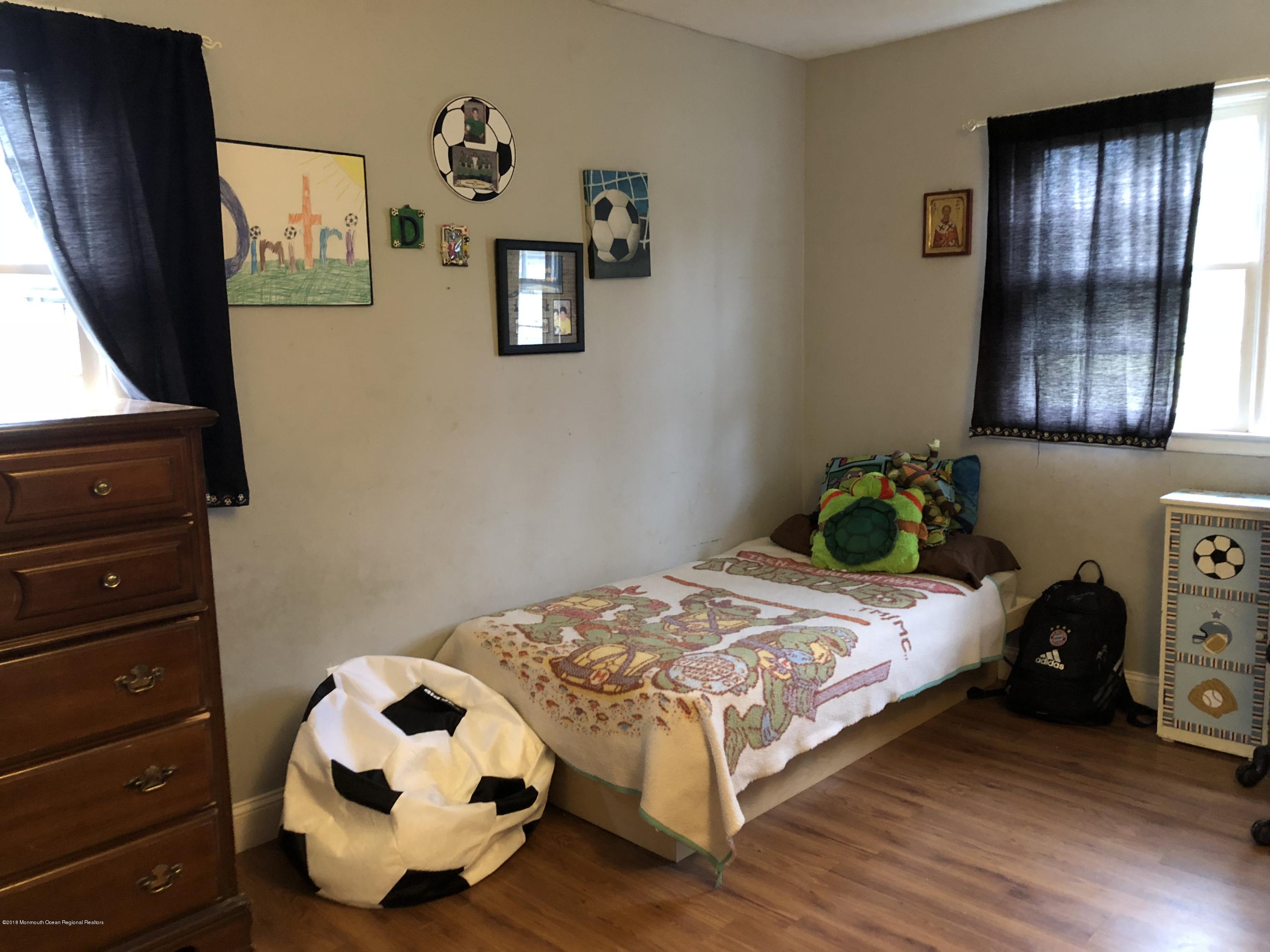 100 Sargent Road Freehold, NJ 07728 - Photo 23 of 30 a bedroom with a bed and wooden floor