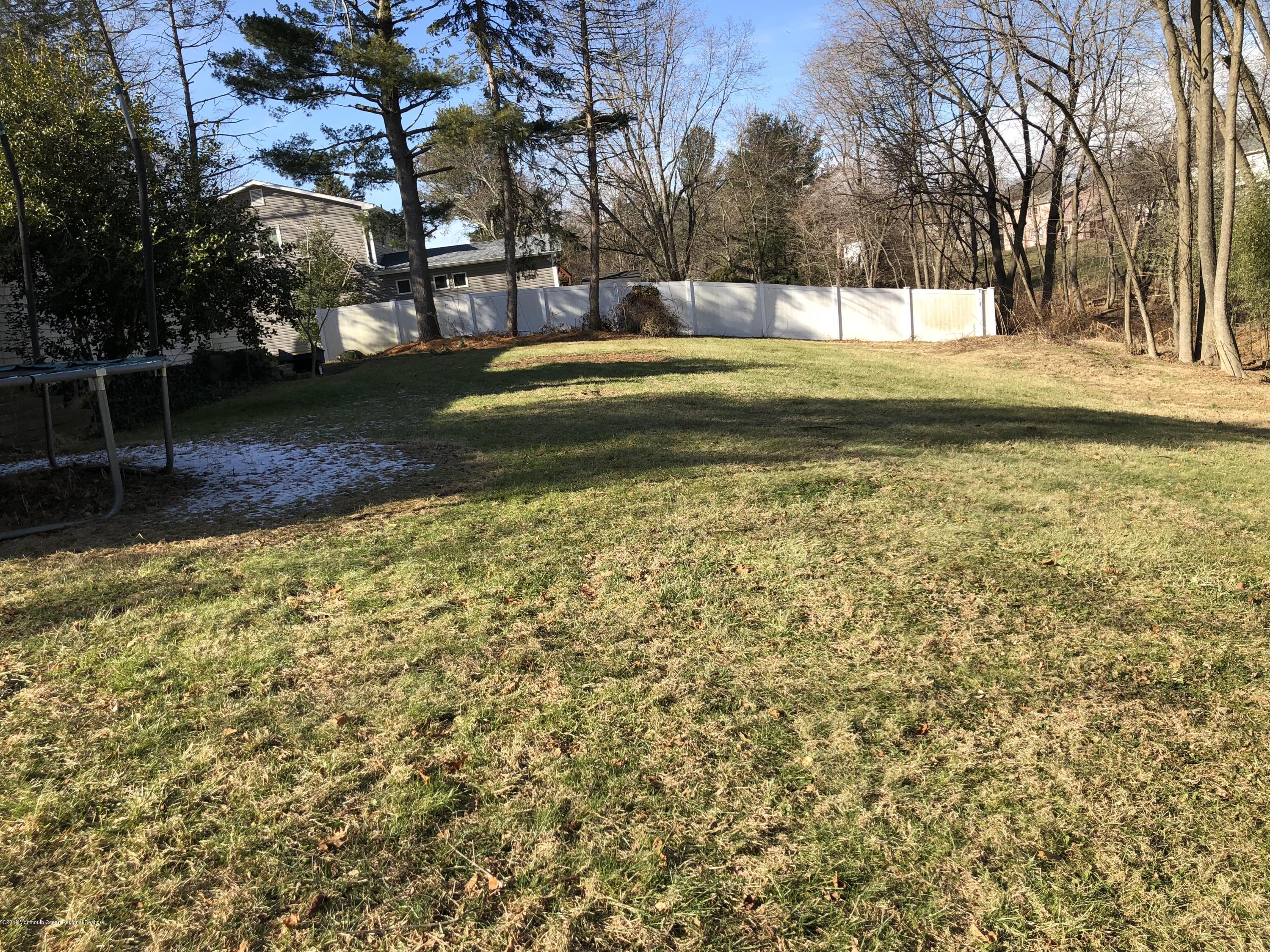 100 Sargent Road Freehold, NJ 07728 - Photo 26 of 30 a backyard of a house with lots of green space