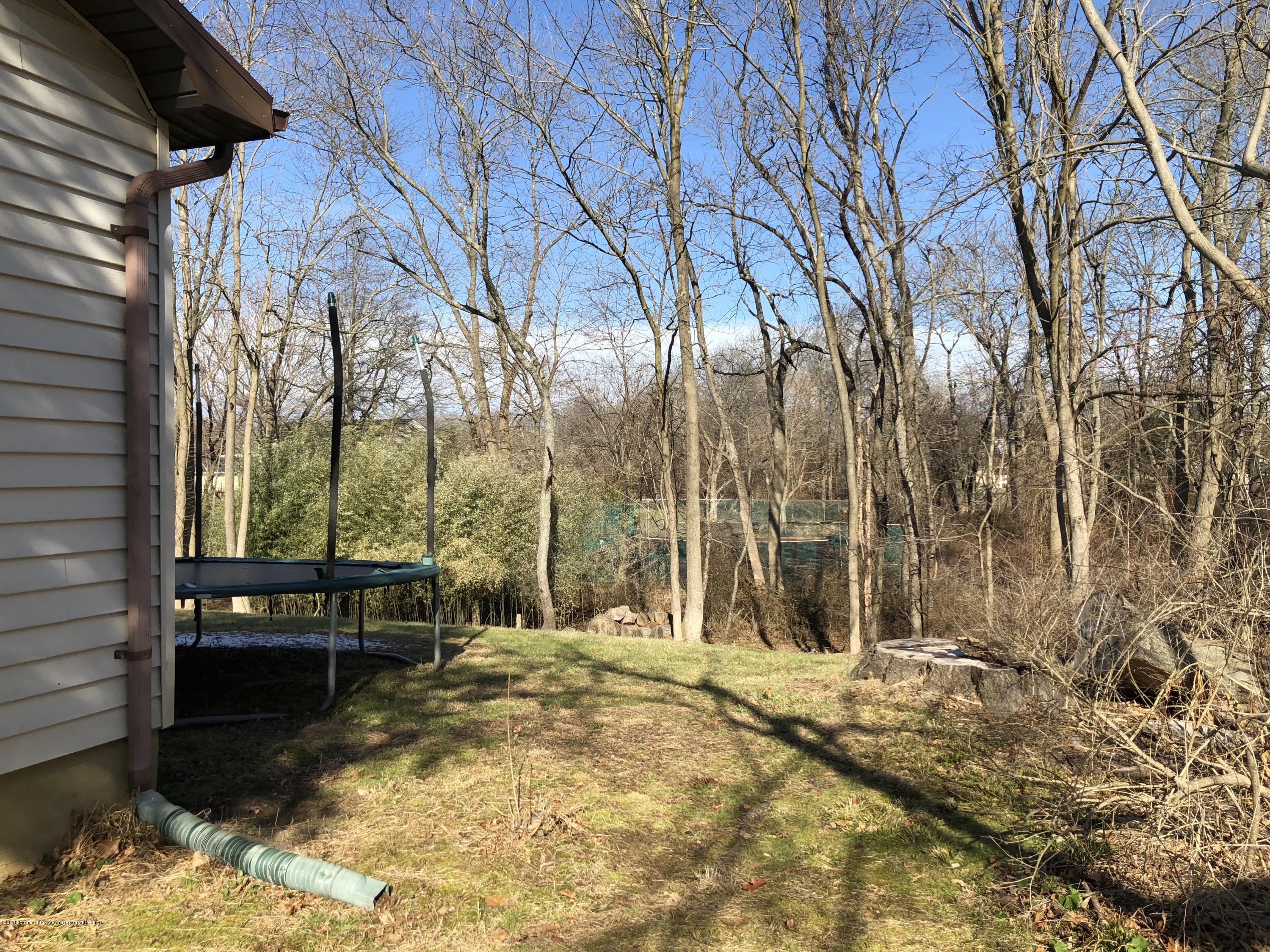 100 Sargent Road Freehold, NJ 07728 - Photo 27 of 30 a backyard of a house with table and chairs