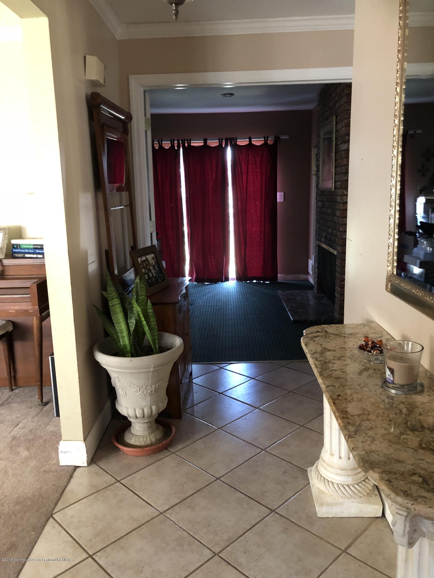 100 Sargent Road Freehold, NJ 07728 - Photo 4 of 30 a view of a living room with furniture and potted plants