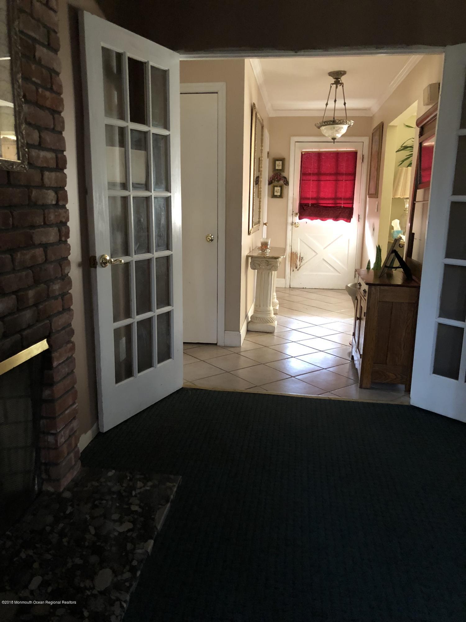 100 Sargent Road Freehold, NJ 07728 - Photo 5 of 30 a view of empty room with wooden floor and windows