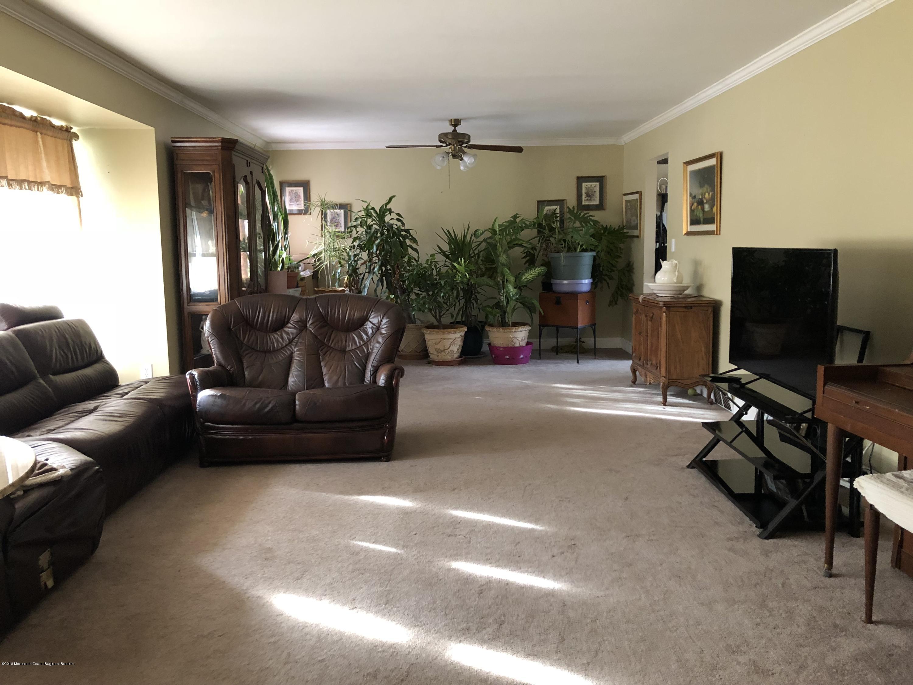 100 Sargent Road Freehold, NJ 07728 - Photo 7 of 30 a living room with furniture and a flat screen tv
