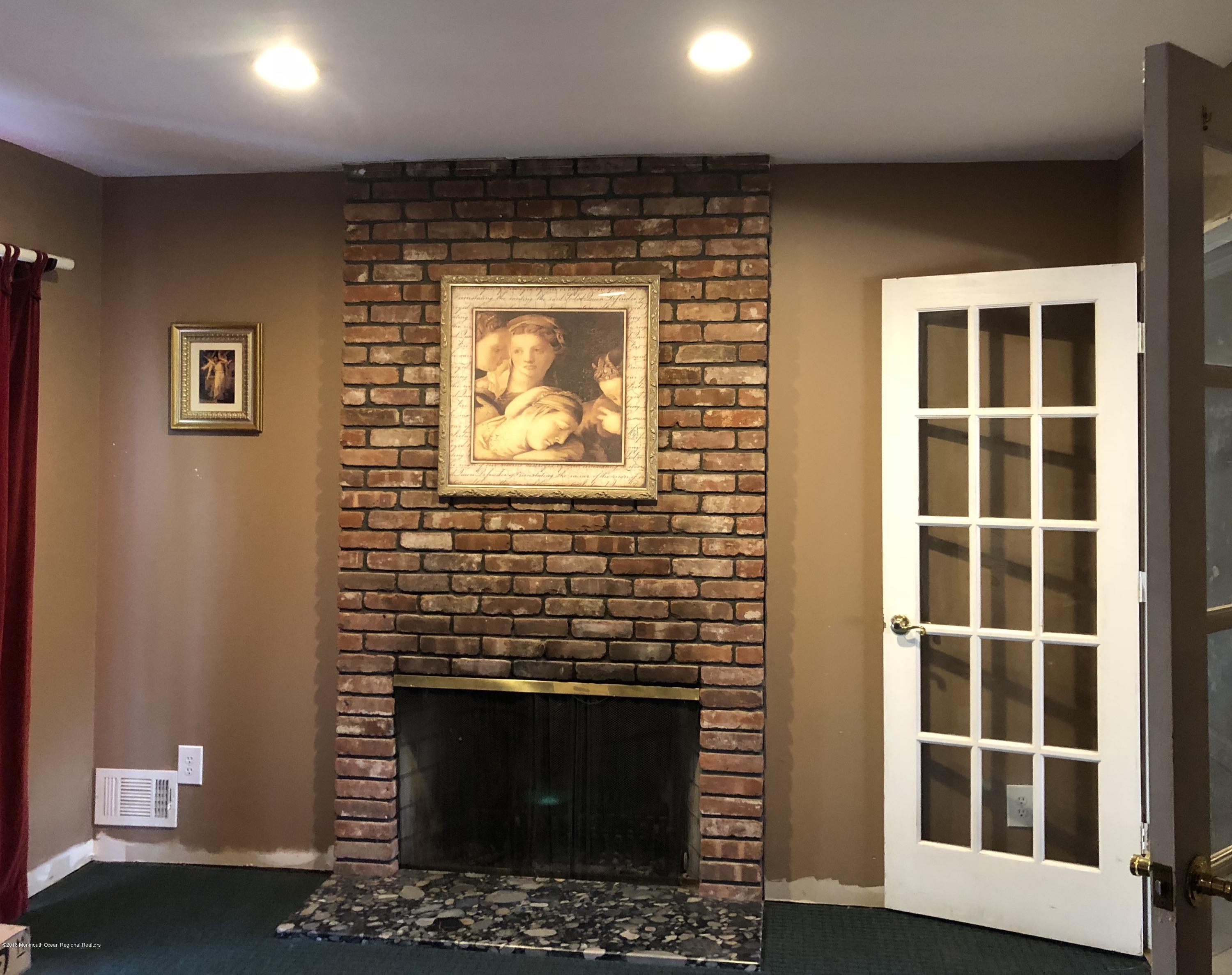100 Sargent Road Freehold, NJ 07728 - Photo 8 of 30 a view of an empty room with a fireplace