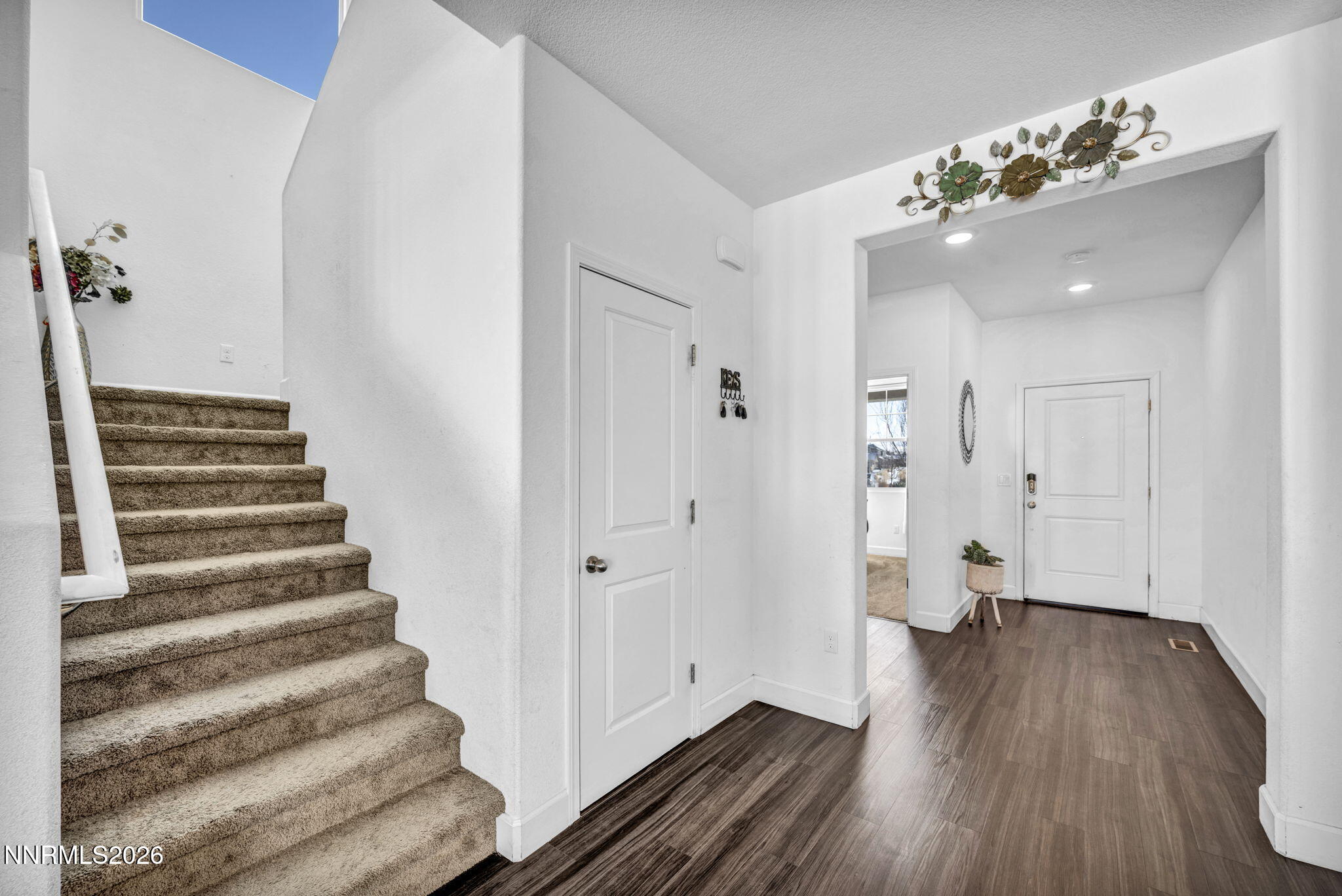 969 Estuary Circle Reno, NV 89506 - Photo 16 of 38 a view of a hallway with wooden floor and staircase