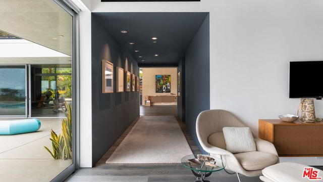 a bedroom with furniture and a large window