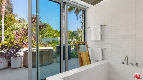 a view of a swimming pool with a patio and a yard