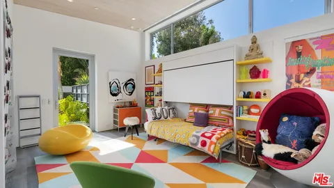 a view of a table and chairs under an umbrella in the yard