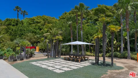 a living room with furniture kitchen view and a window