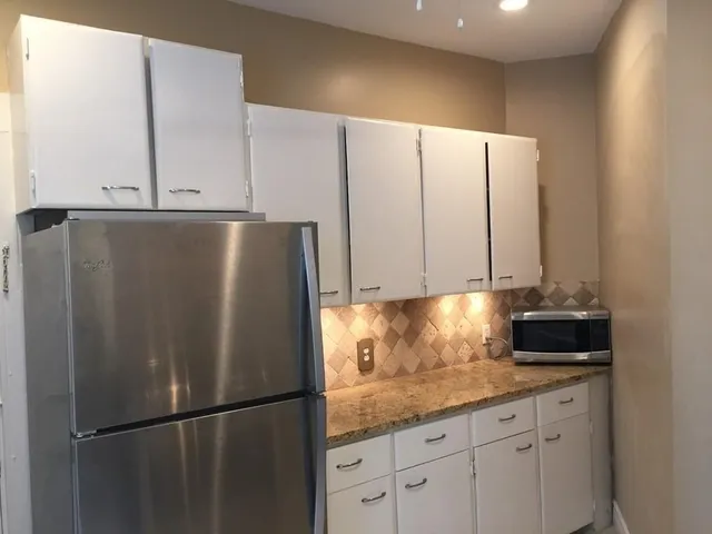 a kitchen with appliances and cabinets