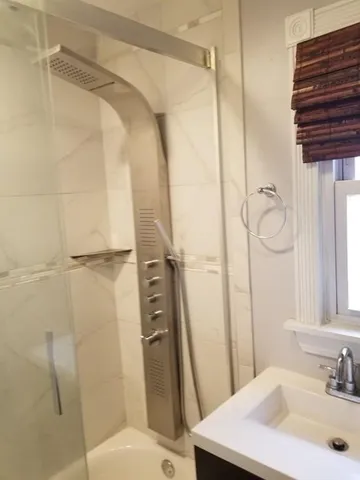 a bathroom with a sink toilet and shower