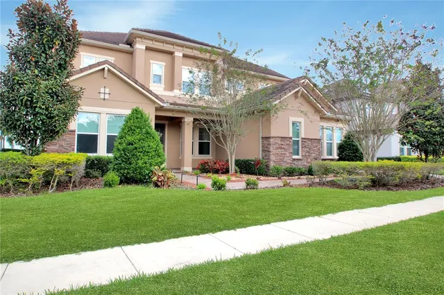 a front view of a house with a garden and plants