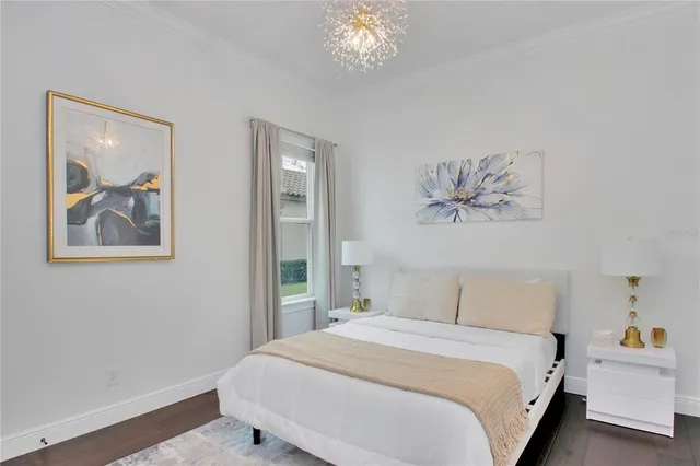 a bedroom with a bed and a painting on the wall