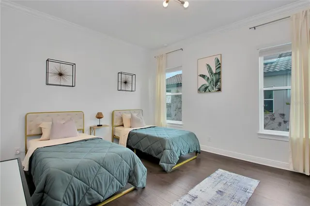 a bedroom with two beds and painting on the wall