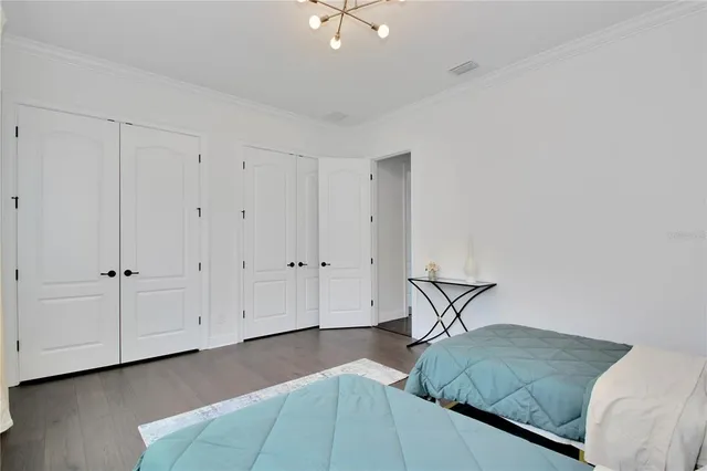 a bedroom with a bed and a ceiling fan