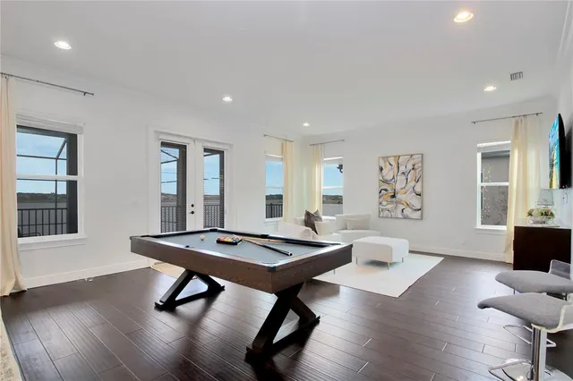 a living room with furniture a table and wooden floor