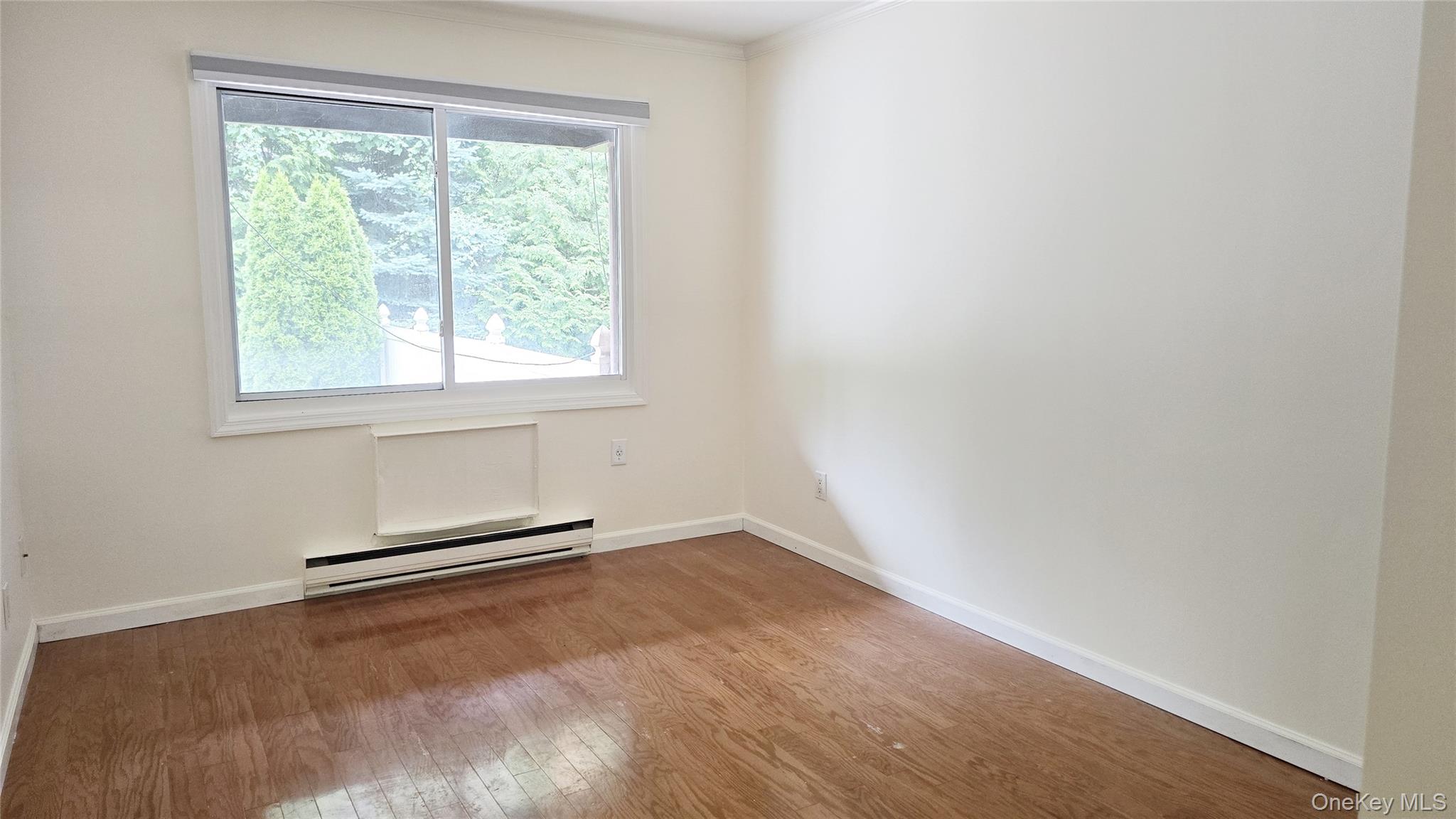 209-08 23rd Avenue Queens, NY 11360 - Photo 11 of 26 an empty room with a window