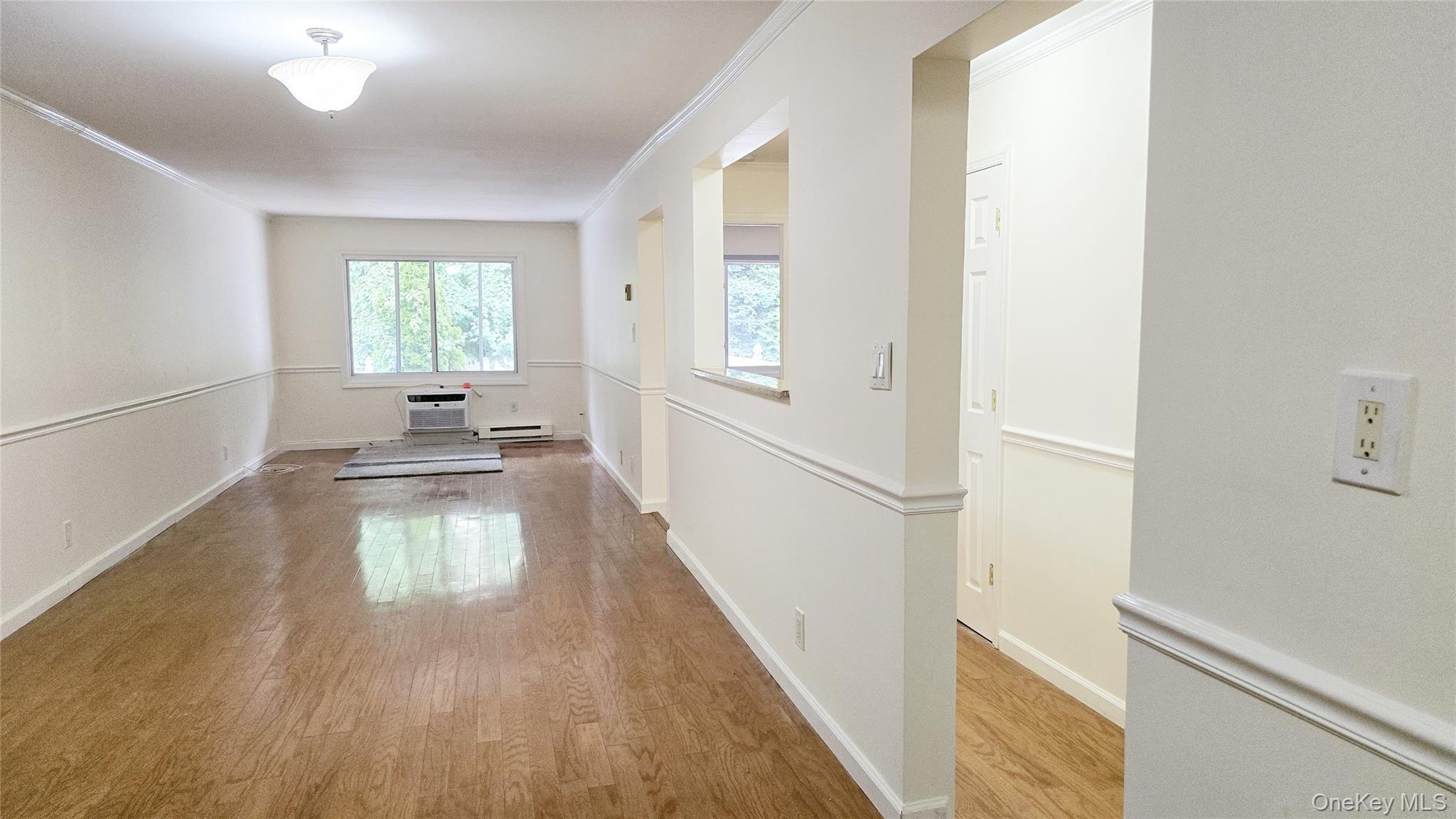 209-08 23rd Avenue Queens, NY 11360 - Photo 13 of 26 a view of empty room with wooden floor and fan