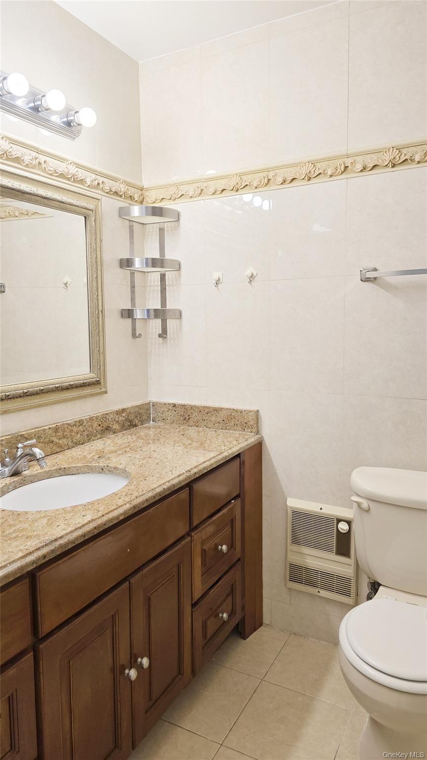 209-08 23rd Avenue Queens, NY 11360 - Photo 14 of 26 a bathroom with a granite countertop sink toilet and shower