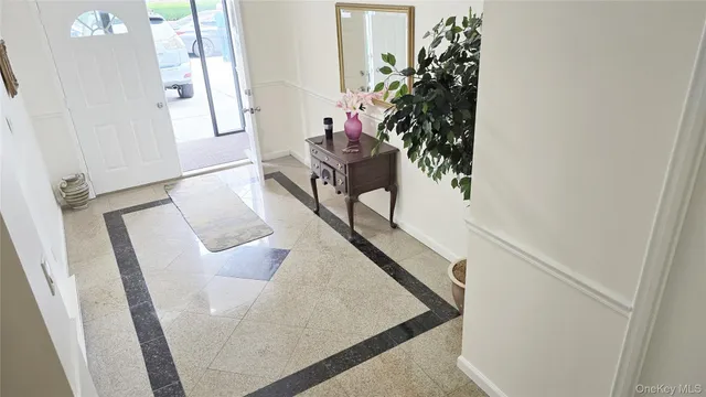 a view of living room with furniture and a potted plant