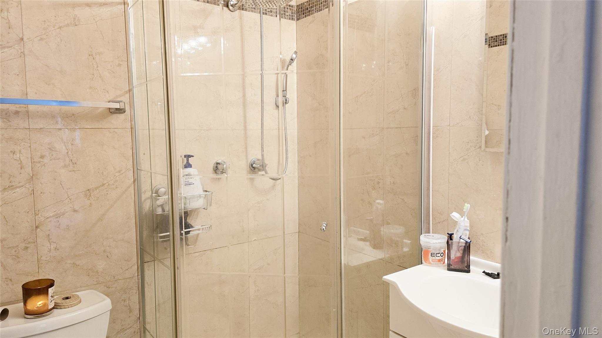 209-08 23rd Avenue Queens, NY 11360 - Photo 9 of 26 a bathroom with a sink a toilet and shower