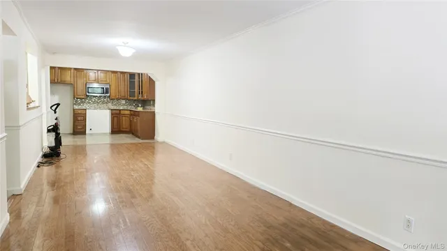 a view of a kitchen with wooden floor